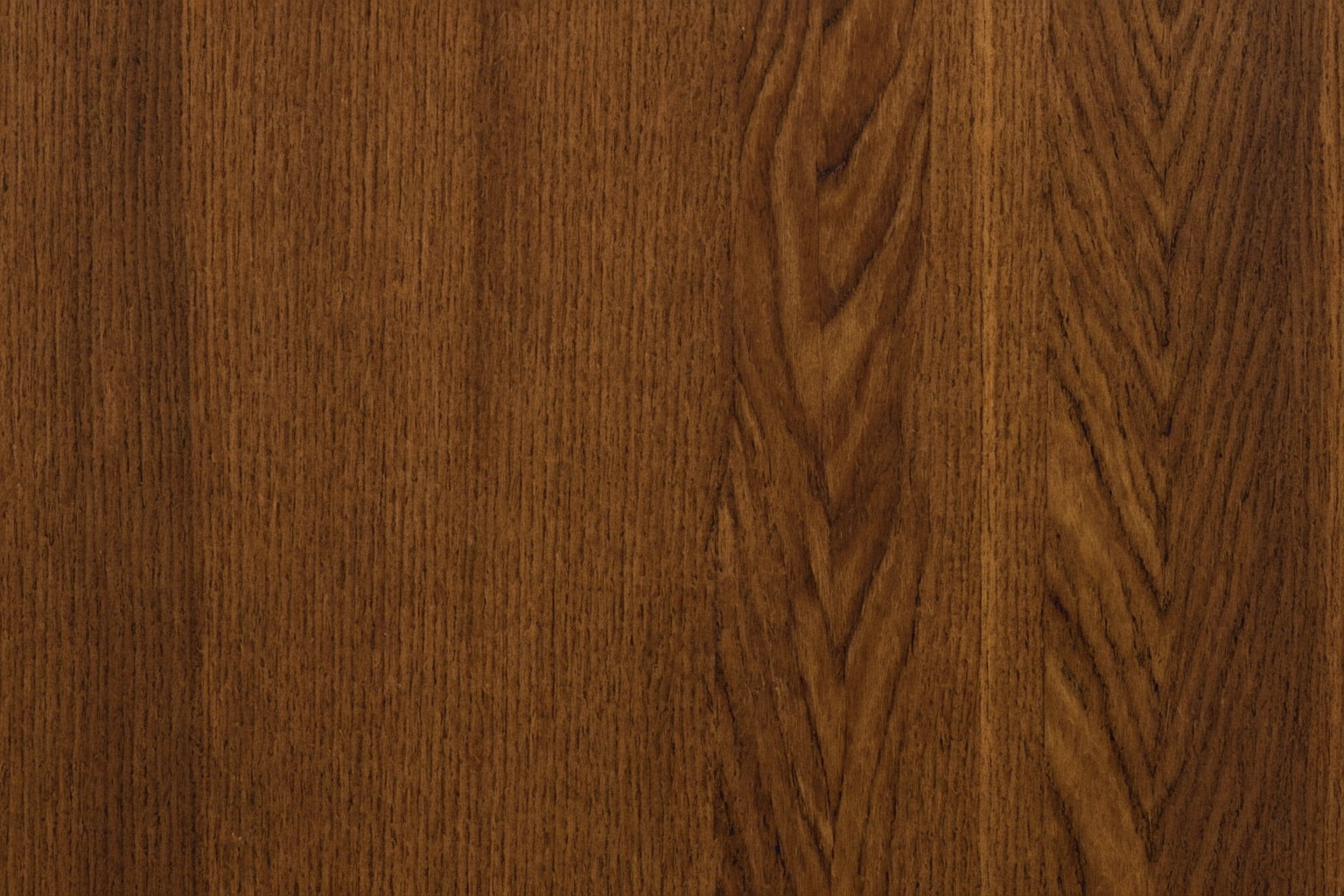 Macro view of book-matched walnut veneer showing mirrored grain across a joint
